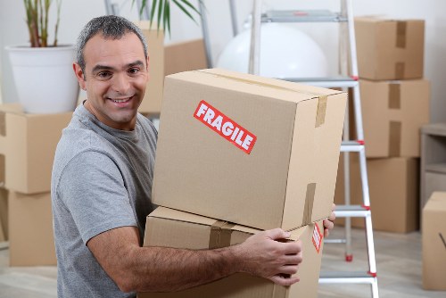 Man with van parked outside a Wimbledon terrace ready to load furniture